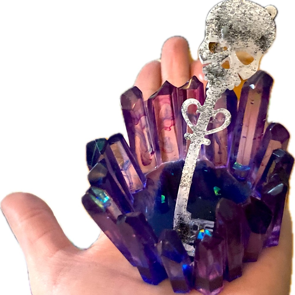 Epoxy resin crystal candle holder with a little skeleton key .